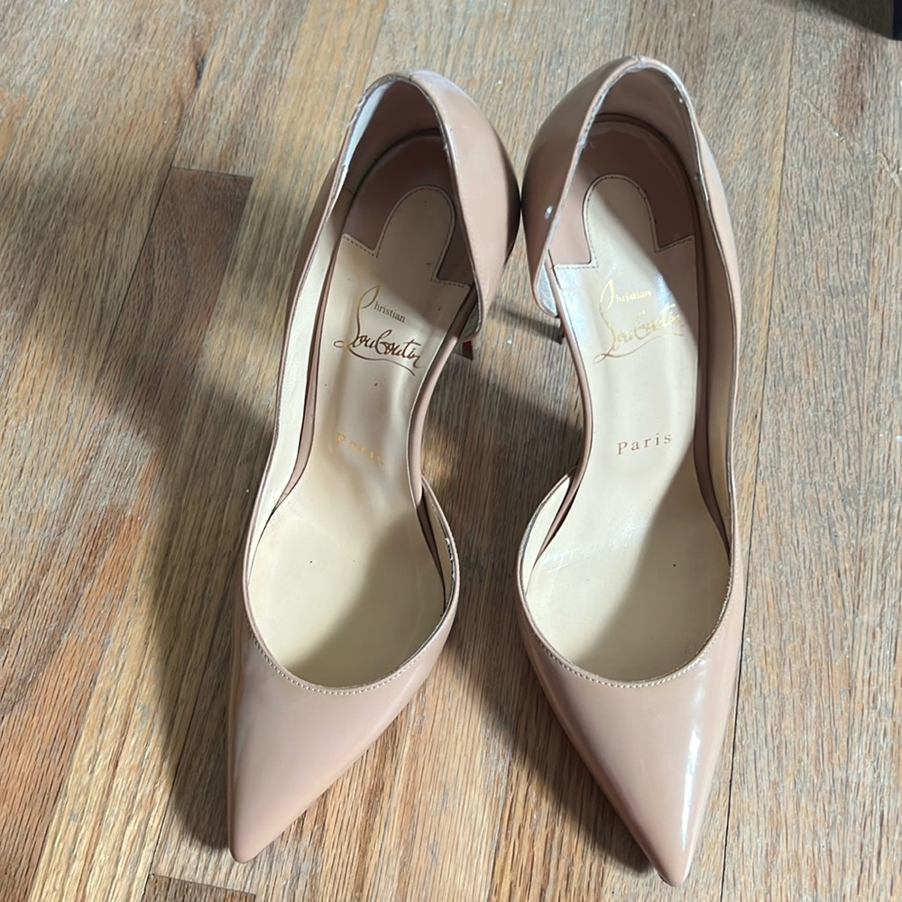 CHRISTIAN LOUBOUTIN
Iriza Patent 100mm Half-d'Orsay Red Sole Pumps Size 38